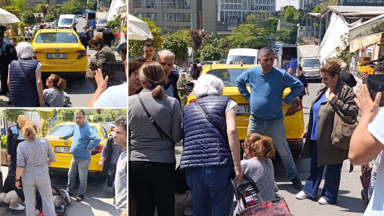 Geri geri giden taksi, yaşlı kadını altına aldı