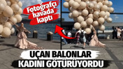 U&ccedil;an balonlar kadını g&ouml;t&uuml;r&uuml;yordu. Fotoğraf&ccedil;ı havada kaptı