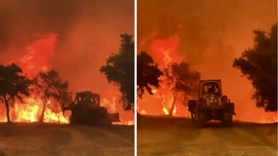 Evlere yaklaşan alevleri dozeriyle durdurmaya çalıştı