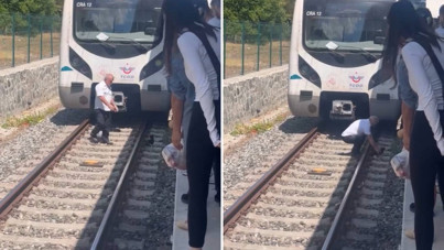 Yavru kediyi kurtarmak için treni durdurup raylara atladı
