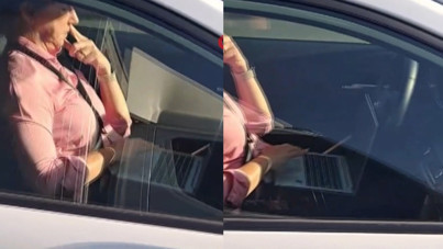 Kucağında bilgisayarla otomobil kullandı