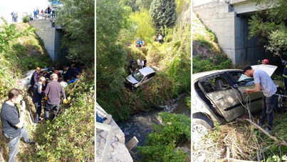 Tekerleği fırlayan otomobil 20 metreden dereye uçtu